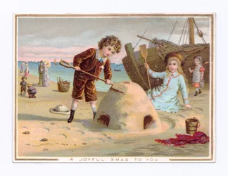 Viktoriaaninen joulukortti pojasta, joka rakentaa hiekkalinnaa rannalle, n. 1880 (värilitho)