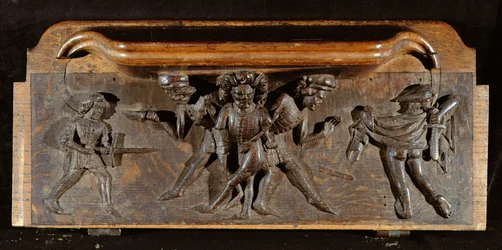 Vioittunut kurjuusormi, joka kuvaa kolmea miestä taistelemassa tikareilla ja miekoilla, New College Chapel, Oxford, 1300-luvun loppu (puuta)