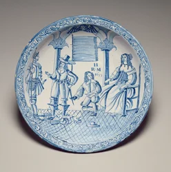 Astia, jossa kuningatar Katariina istuu ja polvistuvan Cavalierin asettama kenkä, 1677 (tinalasitettu keramiikka)