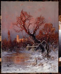 Gatchinan palatsin puistossa Pietarin lähellä. Kuvaus jäätyneestä järvestä, jossa on kiviportaat ja paljaat puut, taustalla palatsi, jota valaisee auringonvalo.