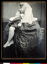 Kreivitär Verasis de Castiglione, o.s. Virginia Oldoini, istumassa pöydällä. Kreivitär nostaa pukuaan paljastaakseen säärensä ja jalkateränsä. Louis Piersonin (1822-1913) hopeagelatiinibromidivedos, 1863, Pariisi, Musée d