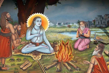 Maalaus, joka kuvaa pyhää miestä (istumassa tiikerin iholla kuin Shiva) seuraajiensa ympäröimänä Haridwar India