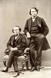 Johannes Brahms (1833-1897) saksalainen säveltäjä, istumassa Joseph Joachimin (1831-1907) unkarilaisen viulistin ja säveltäjän sekä Berliinin konservatorion johtajan kanssa. Puolitoisto valokuvasta (vedos)